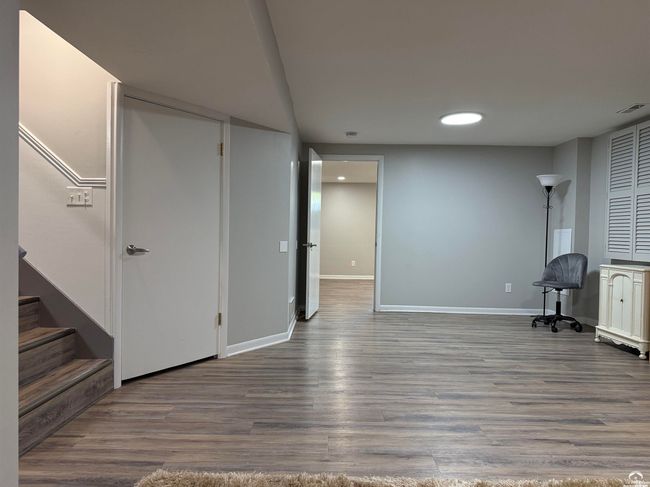 View thru the long rec room; Furnace room on left, East wall bedroom with Full Bath straight ahead | Image 48