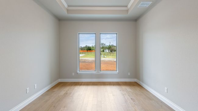 Unfurnished room with light wood-type flooring, crown molding, and a raised ceiling | Image 21