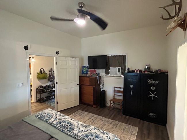 Bedroom with wood finished floors and ceiling fan | Image 8