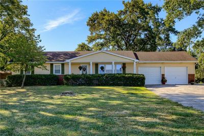 Single story home with a garage and a front lawn | Image 1