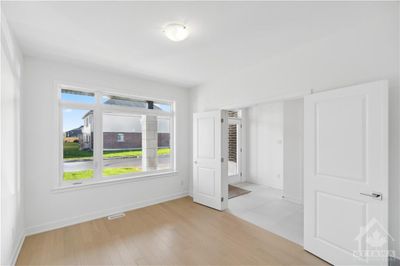 Main floor front office with large window and upgraded hardwood floors | Image 3