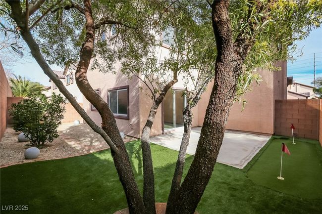 Rear view of property with fence, a patio area, and stucco siding | Image 15