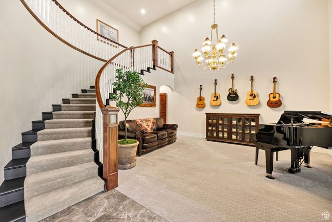 Stairs featuring a towering ceiling, arched walkways, and a chandelier | Image 21