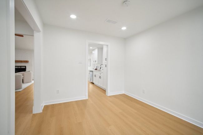 Unfurnished room with recessed lighting, baseboards, light wood-style floors, and a brick fireplace | Image 12