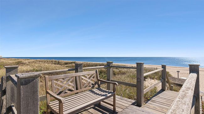 Wooden deck featuring a beach view and a water view | Image 12