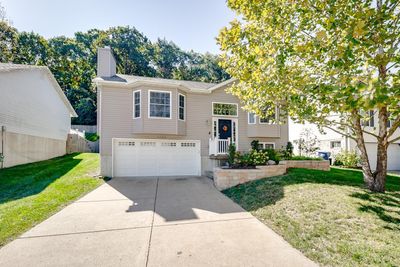 Raised ranch featuring a garage and a front lawn | Image 1