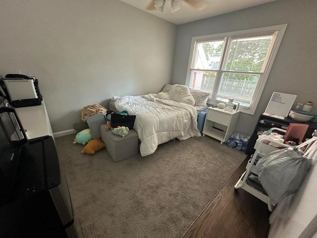 Bedroom with ceiling fan and carpet flooring | Image 7