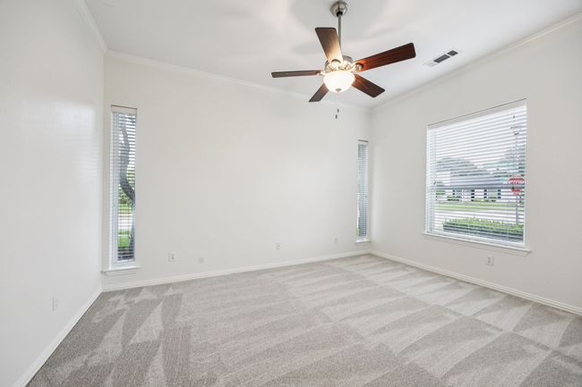 bedroom featuring crown molding, light carpet, ceiling fan, and baseboards | Image 23
