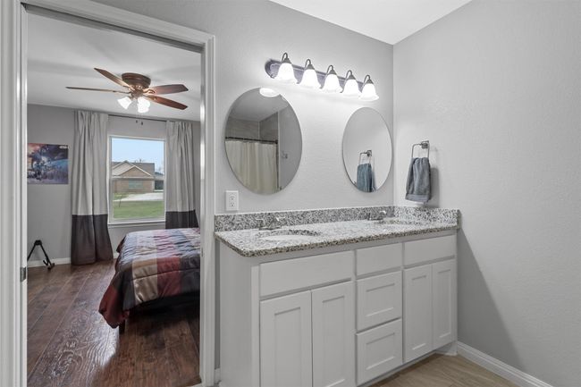 Bathroom featuring a ceiling fan, a sink, and wood finished​​‌​​​​‌​​‌‌​‌‌​​​‌‌​​‌‌​‌​​​​​‌ floors | Image 16