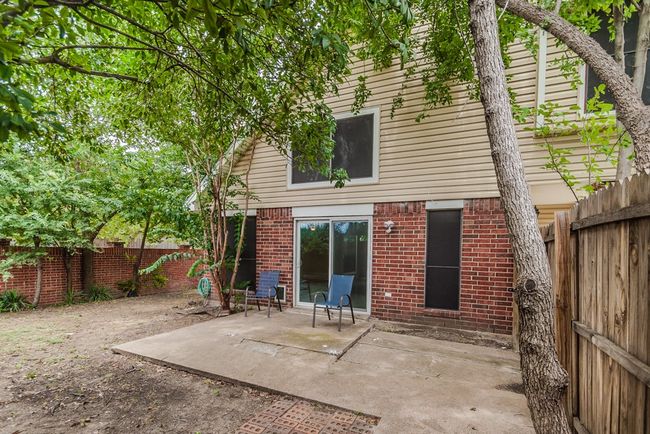 Rear view of property with a patio area, a fenced backyard, and brick siding | Image 20