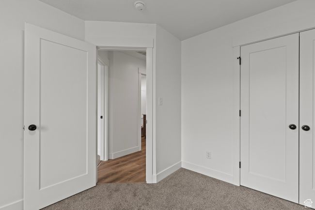 Unfurnished bedroom featuring carpet, baseboards, and a closet | Image 18