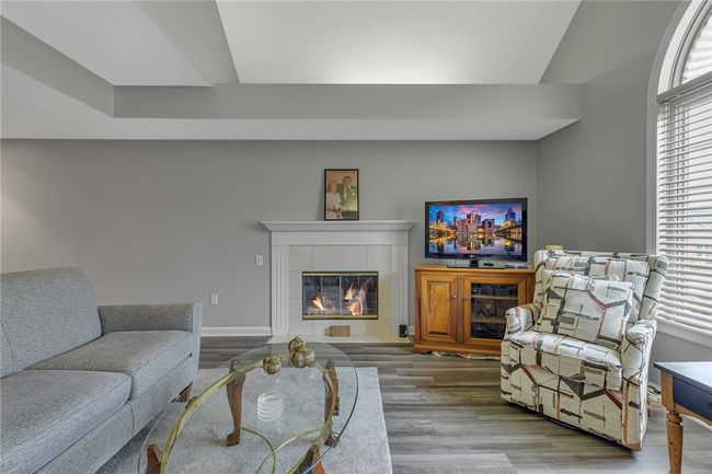 Check out this living room. Notice the vaulted ceiings and the lovely fireplace. | Image 4