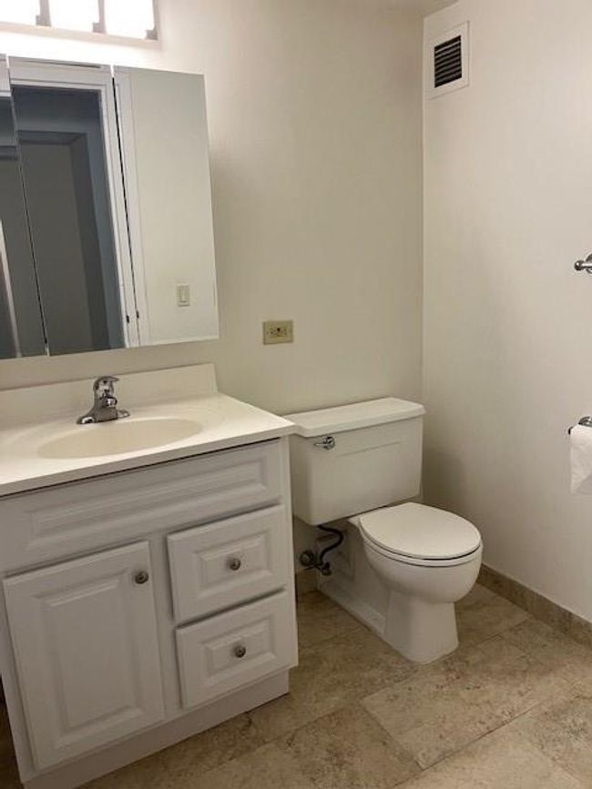 Bathroom featuring vanity, toilet, and tile floors | Image 10