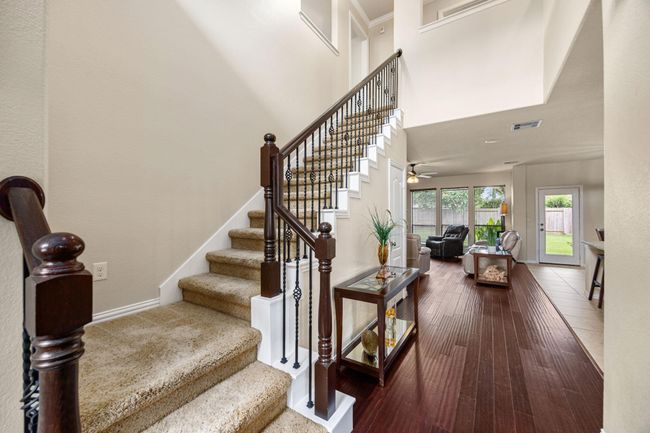 Stairs are just off the front with a half bath hidden just off the landing, keeping it away from common areas for privacy. | Image 6