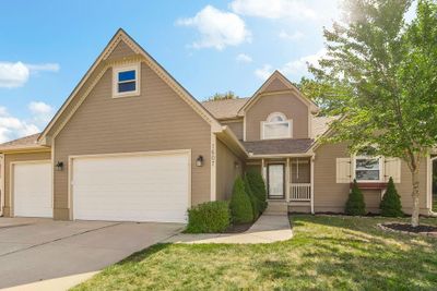 View of front of house featuring a garage and a front lawn | Image 1