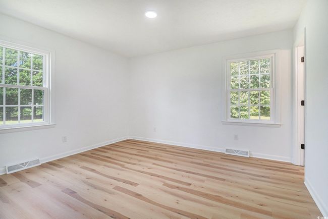 Primary Bedroom featuring an abundance of natural light, LVP flooring, recessed lighting, and en suite bathroom. | Image 19