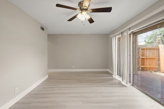 Spare room featuring ceiling fan and light wood finished floors | Image 11