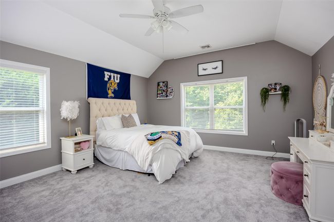 Carpeted bedroom featuring vaulted ceiling and a ceiling fan | Image 29