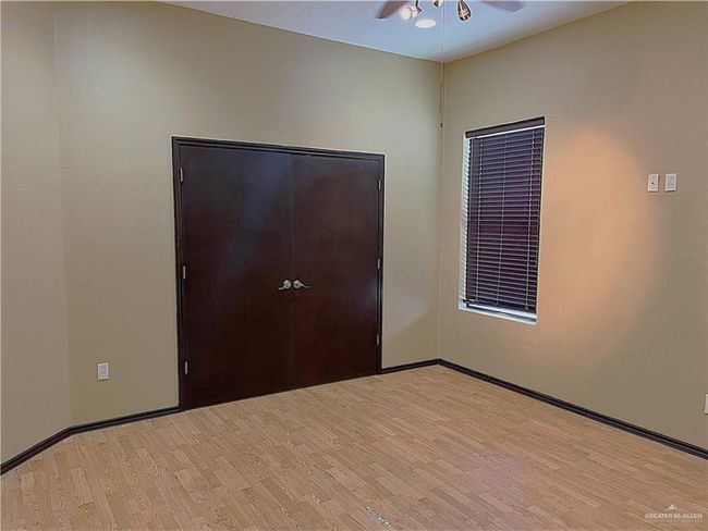 Unfurnished room featuring light wood finished floors, a ceiling fan, and baseboards | Image 20