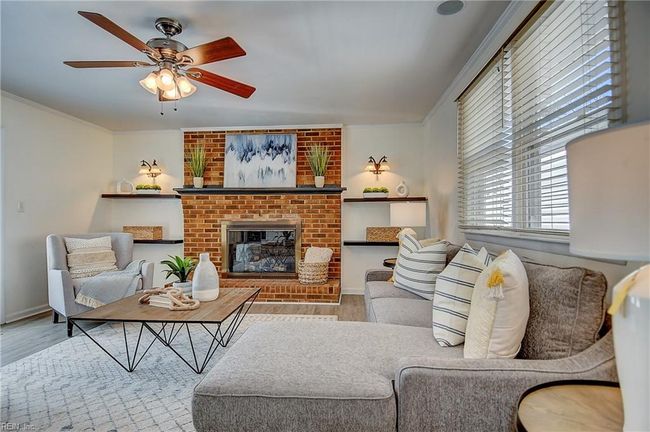 Great room has brand new LVT flooring and gas fireplace. | Image 15