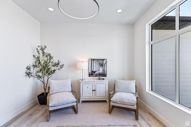 Living area featuring light wood finished floors, baseboards, and recessed lighting | Image 9
