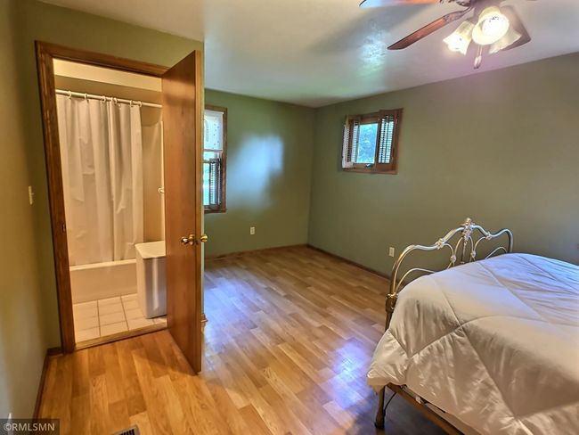 Access to the main floor bathroom through the main floor bedroom offers ease and simplicity. | Image 12