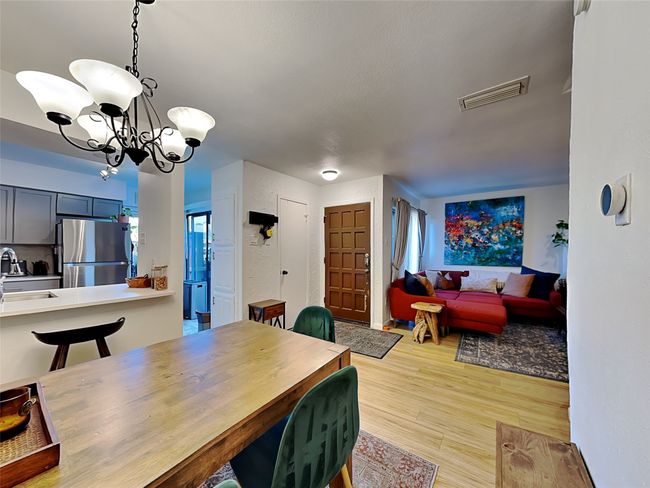 Dining room with a chandelier and light wood-type flooring | Image 5