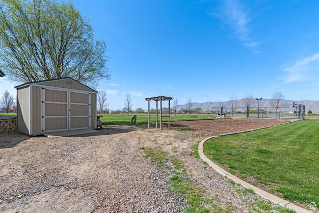 View of yard featuring an outbuilding, a mountain view, and a shed | Image 12