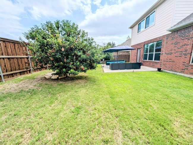 Fenced backyard with a patio area and outdoor lounge area | Image 27