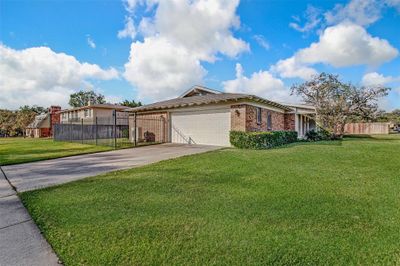 View of front facade with a front yard and a garage | Image 3