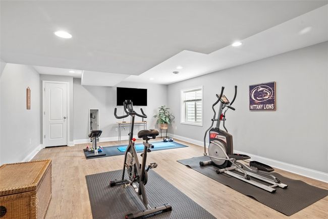 Notice the newer vinyl plank flooring the flows throughout the game room as well as the recessed lights. | Image 40