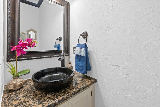 Bathroom featuring a sink and a textured wall | Image 8
