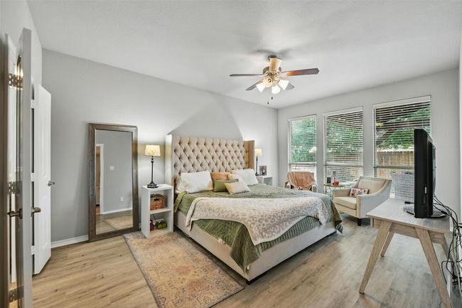 Bedroom with light wood-type flooring and a ceiling fan | Image 28