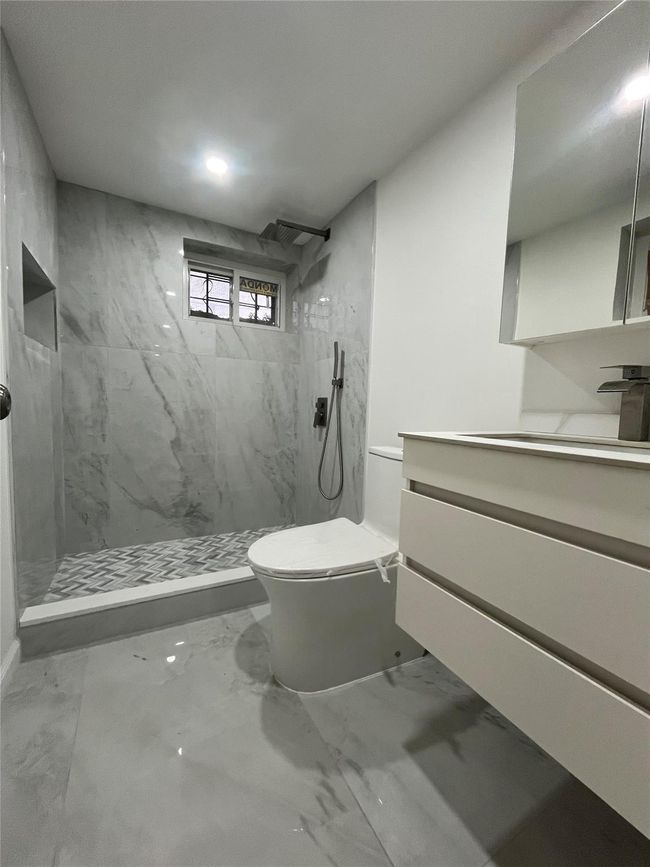 Bathroom featuring marble finish floor, toilet, vanity, and a marble finish shower | Image 9