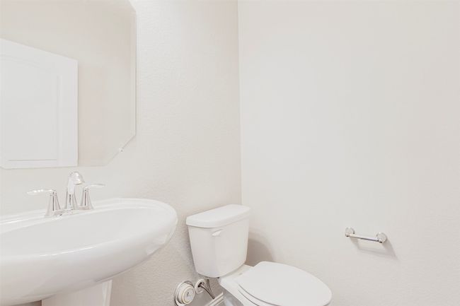 Half bathroom featuring toilet and a textured​​‌​​​​‌​​‌‌​‌‌​​​‌‌​​‌‌​‌​​​​​‌ wall | Image 33