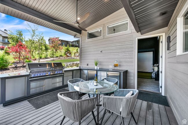 Wooden terrace with outdoor dining space, Grill, two refrigerators and a ceiling fan | Image 58