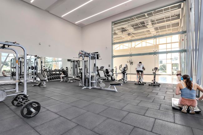 Exercise room featuring plenty of natural light and a towering ceiling | Image 20