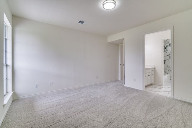 Unfurnished bedroom with light carpet, baseboards, and ensuite bath | Image 19