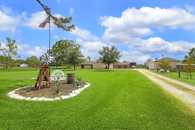 Upon arrival you will be greeted by the new custom designed house sign and landscaping accent, the driveway provides extra space for the ease of bringing in the largest of recreational vehicles, farm equipment or toys | Image 5