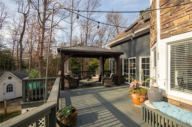Deck with a gazebo, a storage unit, outdoor lounge area, and an outbuilding | Image 40