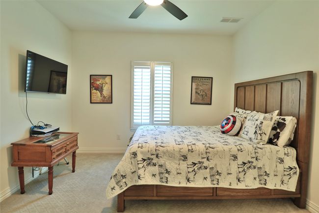 Bedroom featuring visible vents, baseboards, and light carpet | Image 18