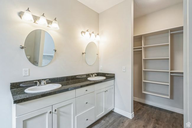 Bathroom with double vanity and wood finished floors | Image 32