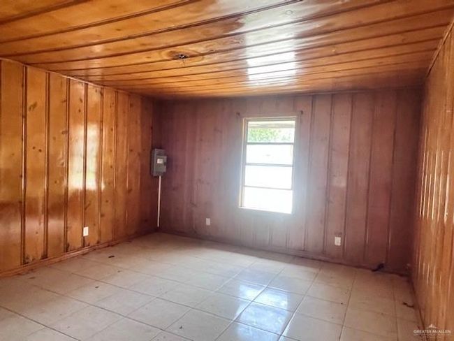 Unfurnished room with wood ceiling and light tile patterned floors | Image 16