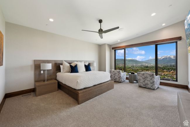 Carpeted bedroom featuring a mountain view, baseboards, a ceiling fan, and recessed lighting | Image 42