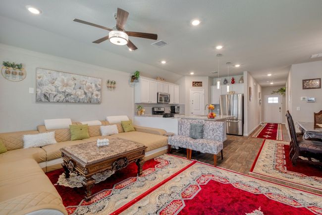 Open concept kitchen, dining & living area with a ceiling fan, and recessed lighting | Image 8