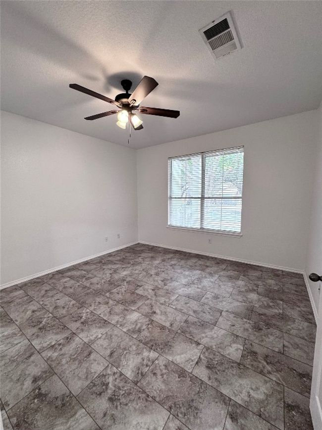 Spare room with ceiling fan and a textured ceiling | Image 10