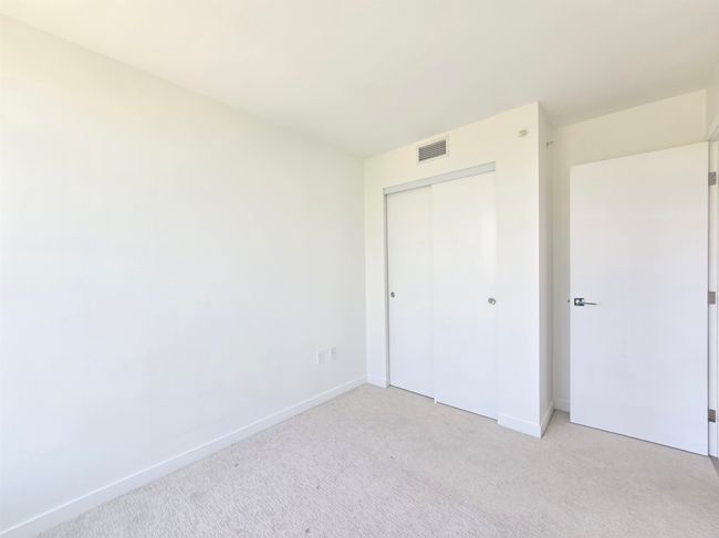 Unfurnished bedroom featuring light carpet and a closet | Image 11