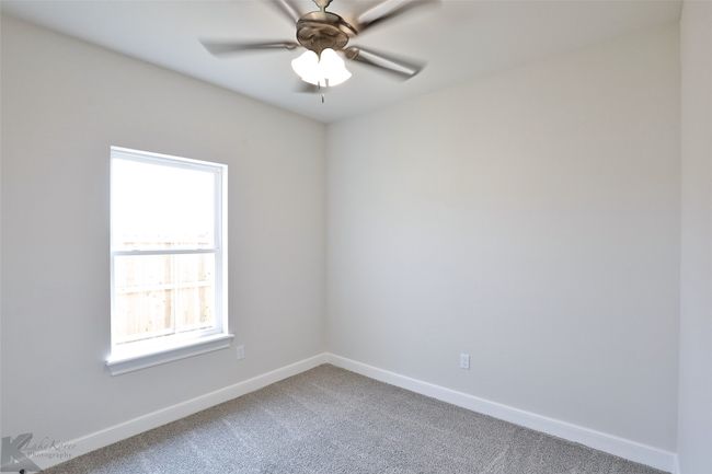 Carpeted spare room with baseboards and a ceiling fan | Image 23