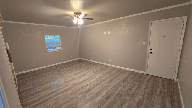 Unfurnished room with wood finished floors, ceiling fan, and ornamental molding | Image 8