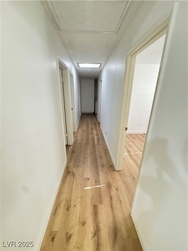 Corridor featuring light wood finished floors and attic access | Image 40